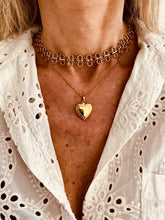 Load image into Gallery viewer, Model wearing round hollow stainless steel skeleton chain necklace styled as a bold yet timeless statement piece for everyday wear.
