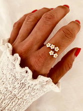 Load image into Gallery viewer, Otta gold floral ring featuring a natural shell flower and sparkling zircon accents worn on hand
