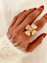 Load image into Gallery viewer, Playful beige flower ring styled on hand with bold floral design
