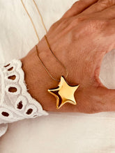 Load image into Gallery viewer, Bold gold stainless steel star pendant necklace with sculpted star charm on a fine delicate chain designed for a modern rock glam statement look
