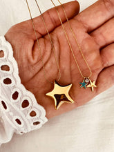 Load image into Gallery viewer, Detailed view of turquoise blue starfish pendant highlighting vibrant color contrast against gold chain
