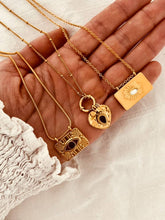 Load image into Gallery viewer, Statement gold sun pendant necklace styled for bold day and evening outfits
