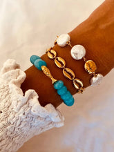 Load image into Gallery viewer, Ocean blue bracelet styled in a coastal summer jewelry stack
