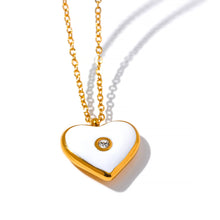 Učitaj sliku u preglednik galerije, Close up of heart pendant with white enamel and central zircon detail
