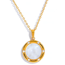 Učitaj sliku u preglednik galerije, Close up of shell pendant with gold border and small zircon accents
